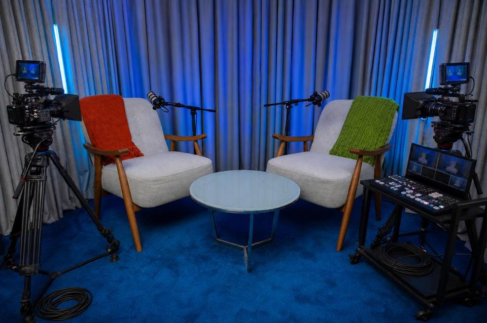 Interior of the Casa Media recording studio in Nairobi, lit blue and ready for a session, with two chairs on microphone between a pair of cinema cameras.